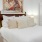 a bed with a painting on the wall