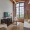 a living room with brick wall coffee table couch and tv