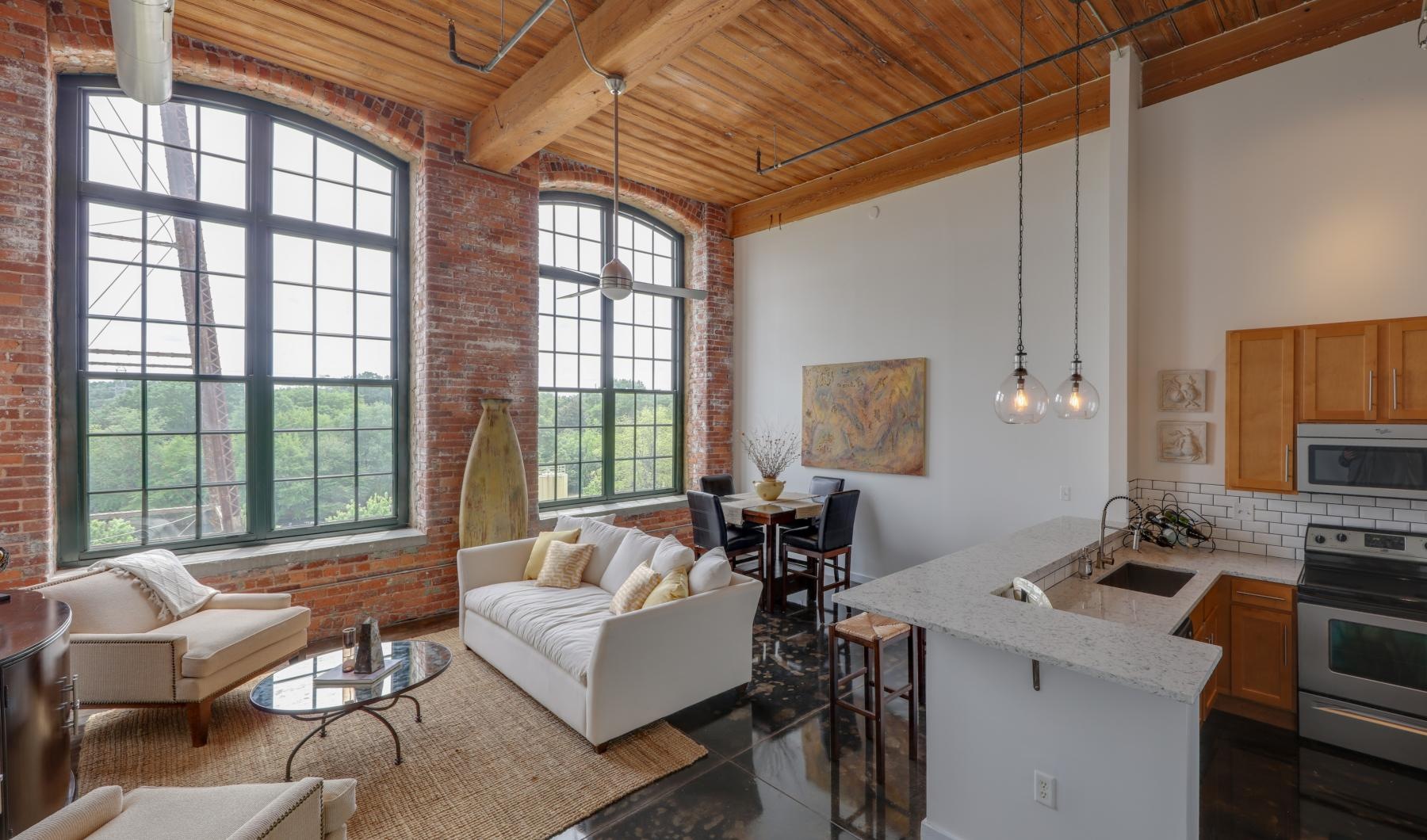The essence of exceptional living a large living room with a brick wall and a white couch