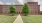 a large brick building with trees in front of it