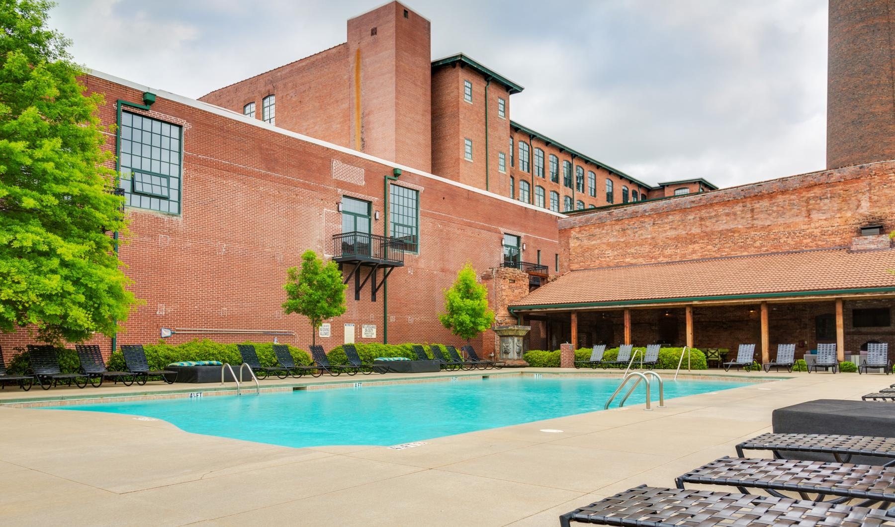 Sparkling swimming pool a swimming pool in front of a brick building